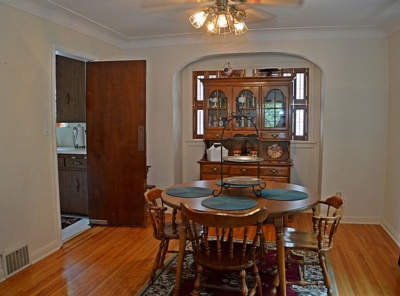 Dining room with wood flooring and alcove for sideboard