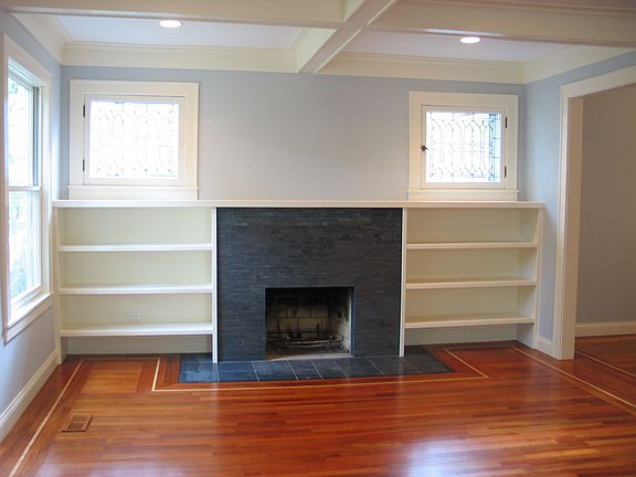 Living room has original stained glass + beamed ceiling