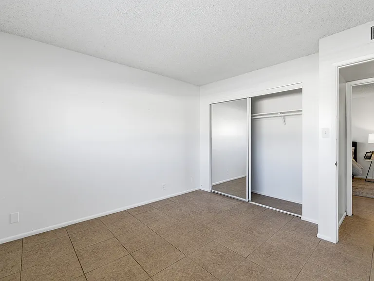 Mirrored closet doors in secondary bedroom
