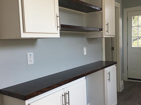 Custom wood coffee bar counter and shelves. Plenty of pantry, display and storage space.