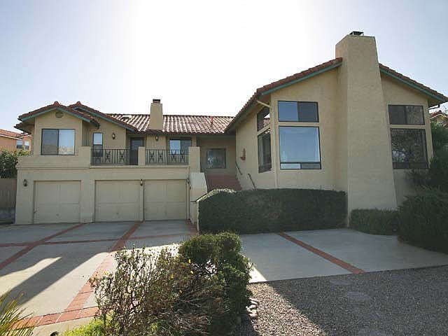 Front of home showing 3-car garage and extra parking