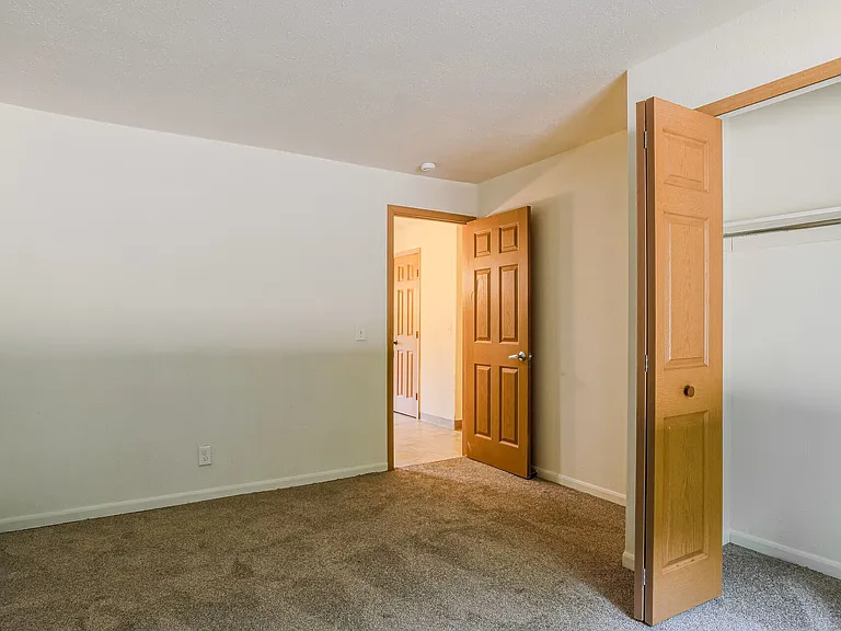 Bedroom, with closet and view to hallway.