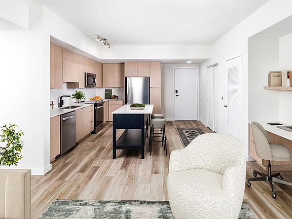 Open-concept kitchens at Modera Aventura pair sleek finishes with the convenience of an in-home office space.