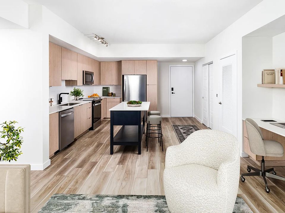 Open-concept kitchens at Modera Aventura pair sleek finishes with the convenience of an in-home office space.