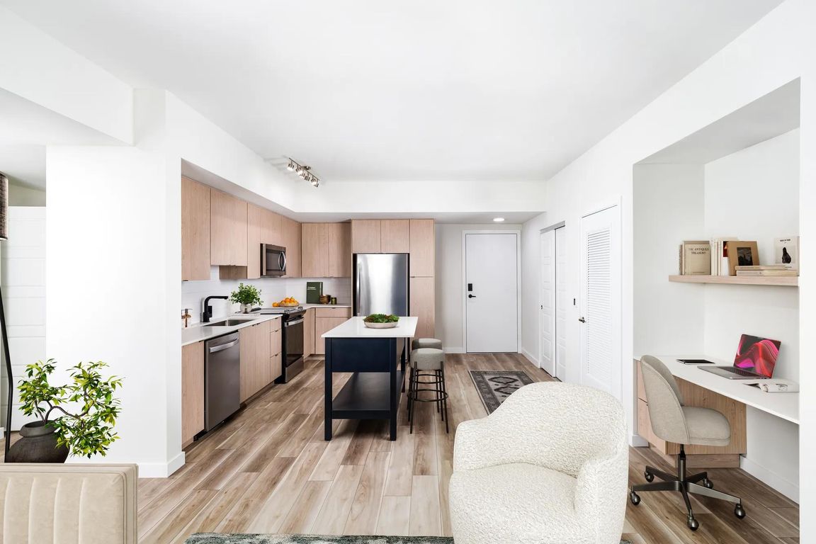 Open-concept kitchens at Modera Aventura pair sleek finishes with the convenience of an in-home office space.