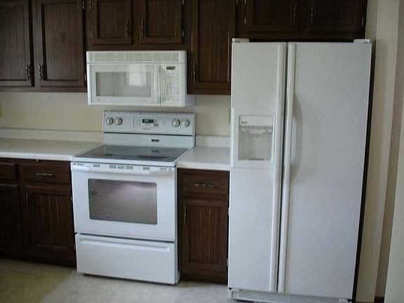 Kitchen showing stove/refrigerator/microwave