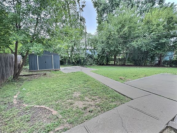 Fenced backyard with storage shed