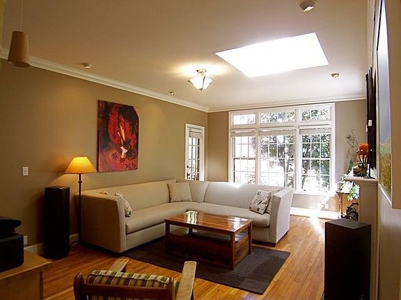 Large Formal Living Room Features Wood Burning Fireplace, Access to Rear Screened Porch And Lots Of 