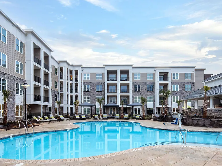 Community Pool with Expansive Sundeck and Lounge Chairs