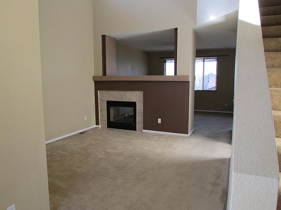 View from high ceiling living room to family room