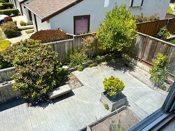 Full deck in back yard with raised bed for flowers, vegetables, etc.