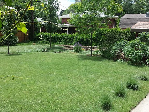 landscaped yard with raised beds garden