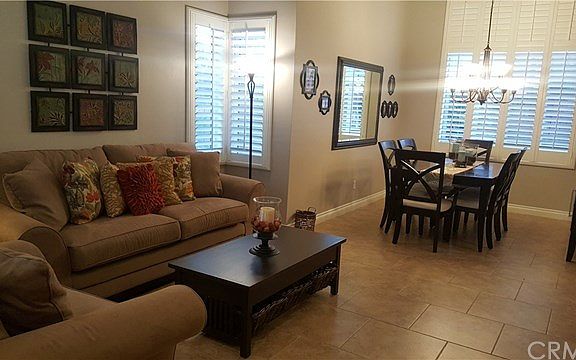 Open and airy floor plan with custom tile flooring leading into dining room and kitchen.  WOW!