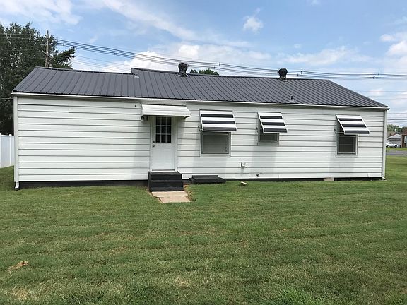 Back at the house, backyard has outside storage building.