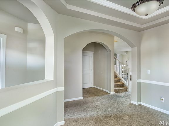 The dining room features an arched entry and accents, coffered ceiling, millwork and more!