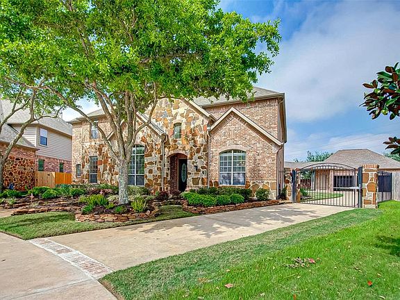 The long driveway boasts an automatic gate that opens to a wider driveway and the three car garage. There's plenty of off-street parking for both homeowners and guests.