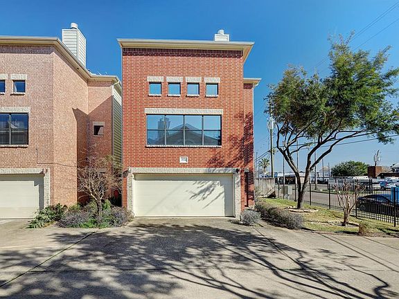 Freestanding 3-story townhouse. End unit l with greenspace on side with the wrought iron driveway gate.