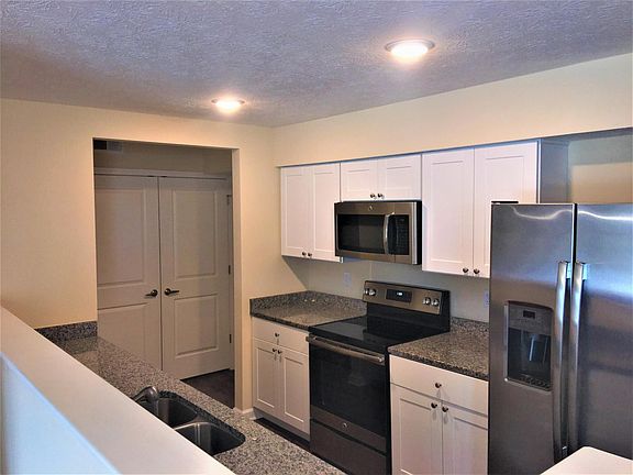 White cabinets with a choice of Granite countertops standard with all homes.