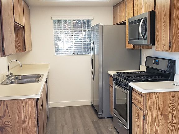 Upgraded kitchen with a new stove, new refrigerator, new microwave and new dishwasher.