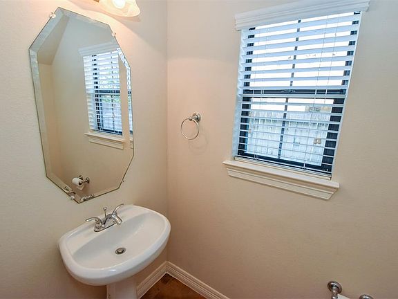 Powder room is conveniently located in the front hall for your guests.
