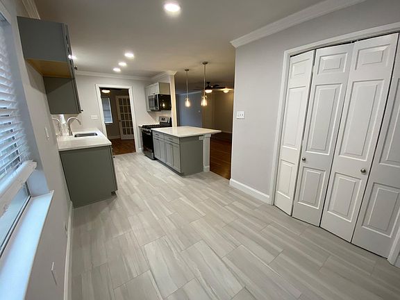 Open kitchen with bar and separate eating area.