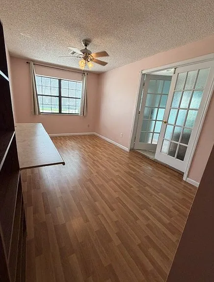 Bonus room. Can be used as another bedroom since it has a closet. Can also be used as an office, hobby room, playroom, etc. French doors lead into living room. The window panels have window film to obscure the view between the two rooms.