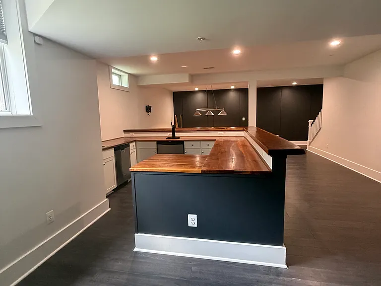 Full wet bar featuring a kegerator, sink, dishwasher, and wine refrigerator.