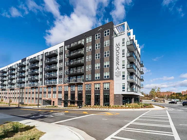 A corner view of Modera Westside Trail highlighting private balconies, layered materials, and a streetscape-focused design rooted in Atlanta's Westside.