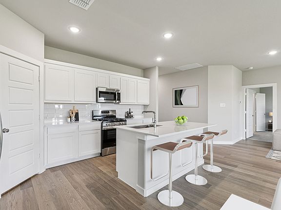 Kitchen in the Harper home plan by Trophy Signature Homes - REPRESENTATIVE PHOTO