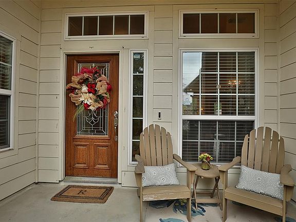 Transom windows let extra natural light in. I can taste that cool drink now while relaxing on this front porch!