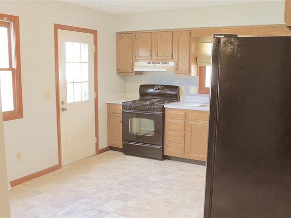 Eat in kitchen with linoleum flooring.