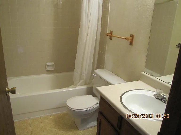 Upper level full bath off hallway between two bedrooms