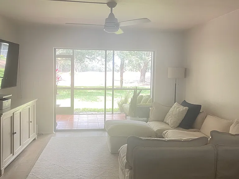 dining room/living room combination opens to lanai and view of Palm Aire County Club golf course