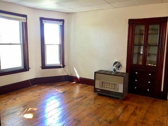 Living room with gas heating stove.