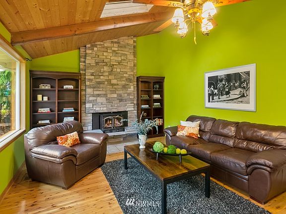 Warm brick fireplace and gleaming hardwood floors.