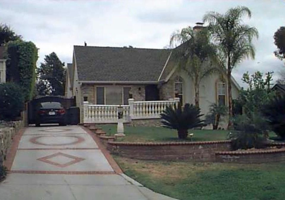 Front of house driveway with gate and garage in back