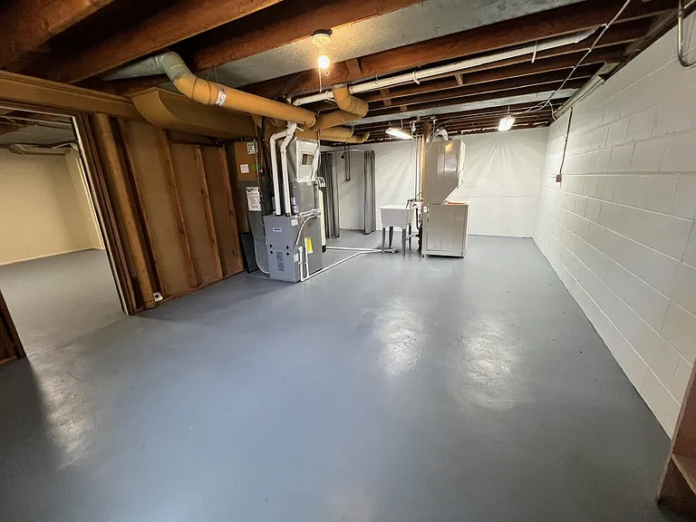 Large basement features private entrance from garage, washer & dryer, large utility sink and bonus shower!