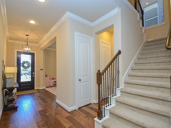 New wide plank wood flooring throughout downstairs, new neutral paint, new crown molding, base boards and iron entry chandelier. Plantation Shutters downstairs bring a custom feel and natural light in each room.