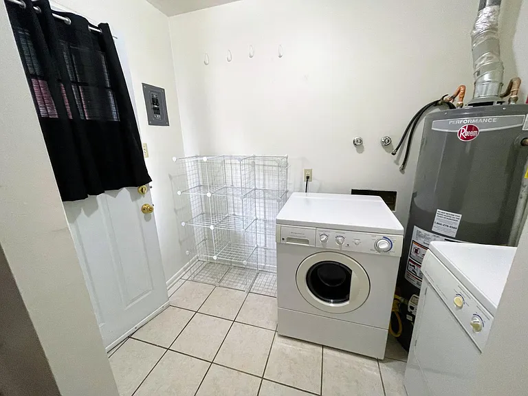 Front/Back door entry from parking spot into Washer & Dryer, storage area and into kitchen.