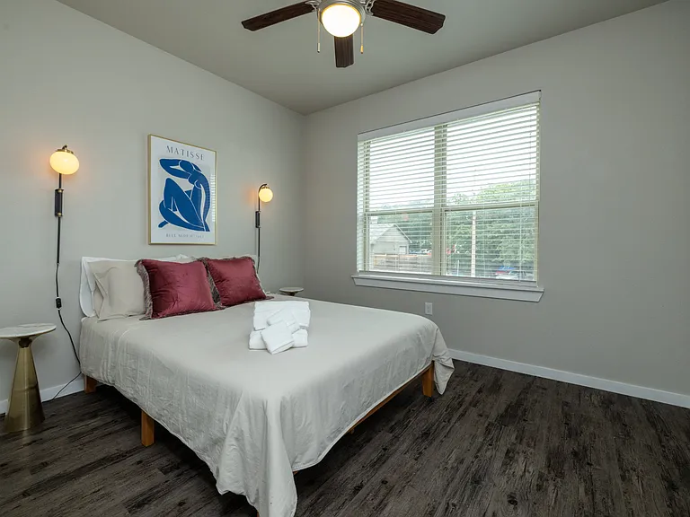 Bright and airy primary bedroom with a cozy queen bed, flooded with natural light_your perfect retreat for rest and relaxation. This bedroom is located on the first floor.