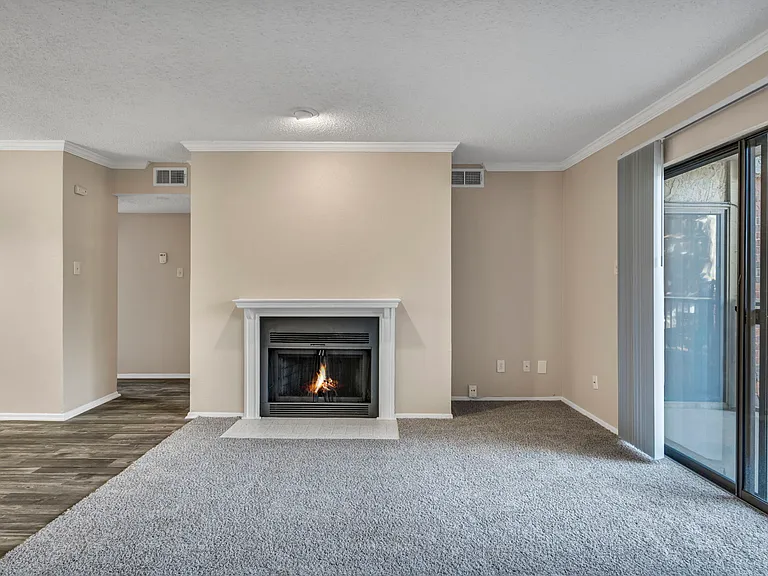 Open living and dining concept with fireplace and easy access to outdoor patio for fresh air!