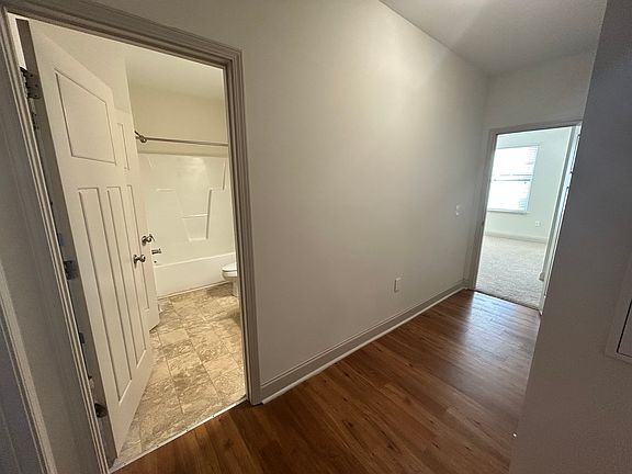 Hallway showing guest bathroom and master bedroom location