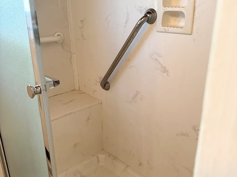 Walk in shower with bench seat and rails