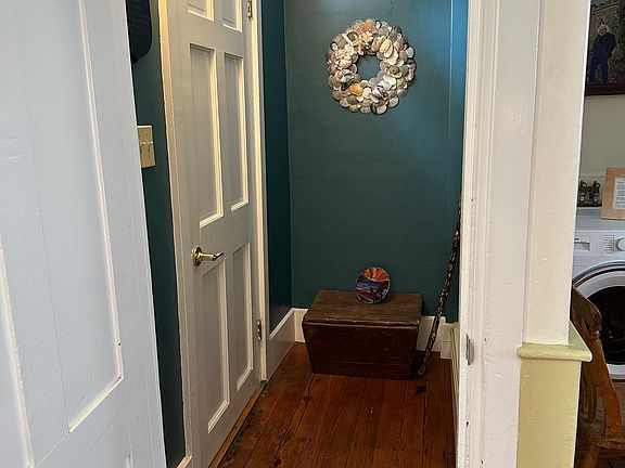 Entry (closed door left) is through the original mud room into the kitchen (open door)
