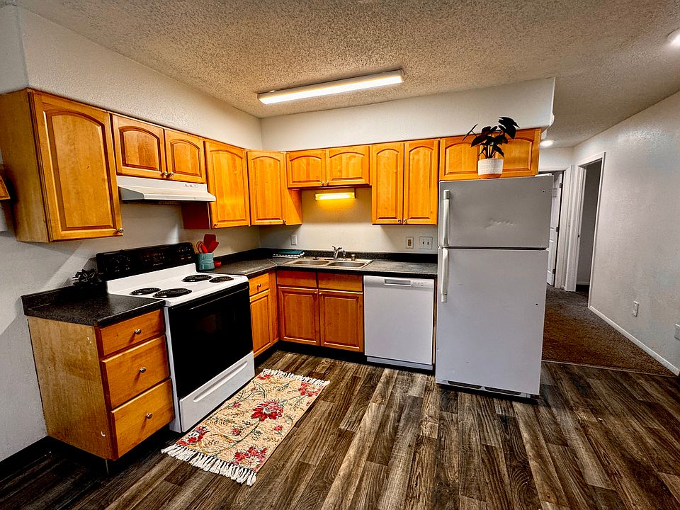 Kitchen with hallway leading to bedrooms and bathroom.