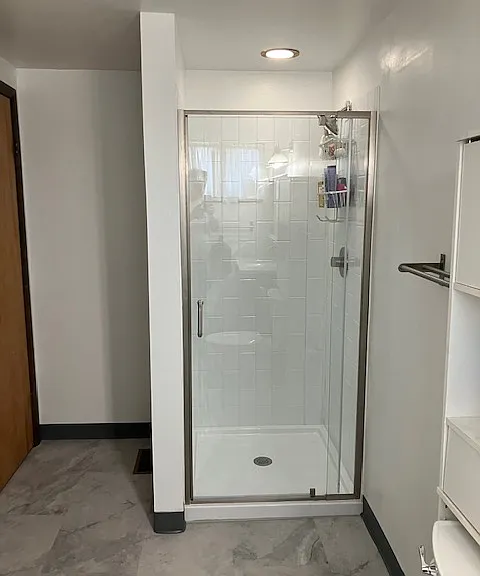 Newly renovated shower with modern glass enclosure