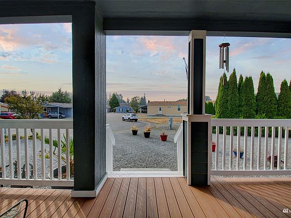 Covered patio faces west to enjoy afternoon sun and evening sunsets views year round.>