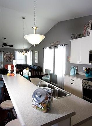 Center island with high overhang to fit several stools to enjoy a breakfast treat.