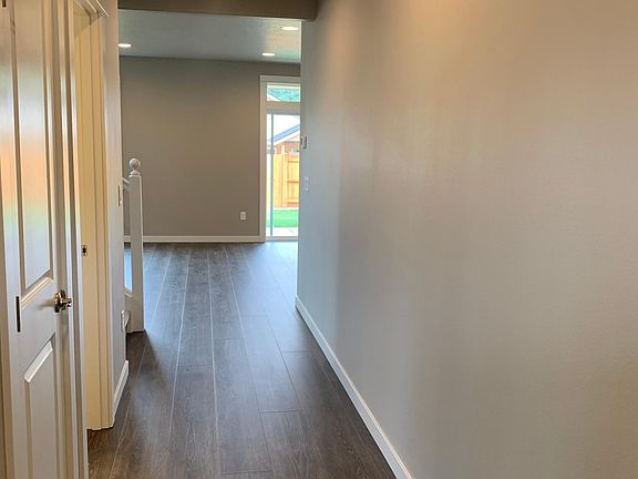 Front entry hall with wide plank flooring throughout first floor.