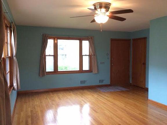 Front door into living room with coat closet.